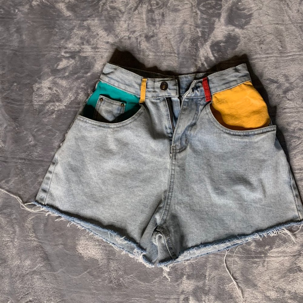 Fabric painted light wash denim shorts.